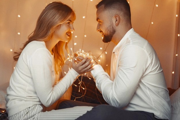 elegant couple sitting with garlands